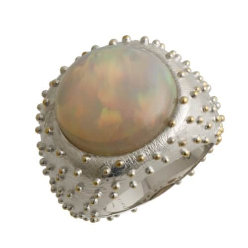 Silver ring with gold and opal stone