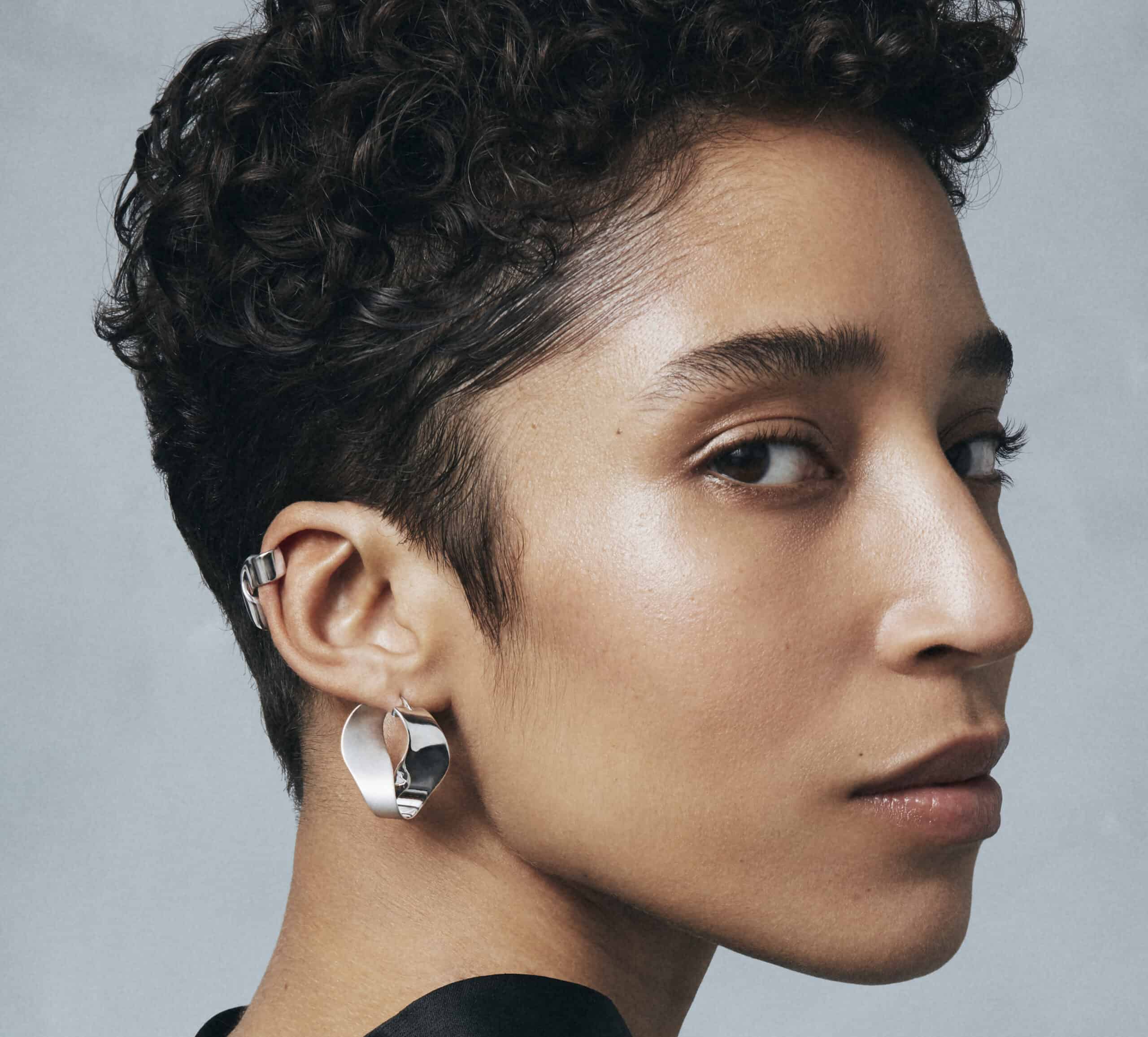 Silver earrings and a black dress